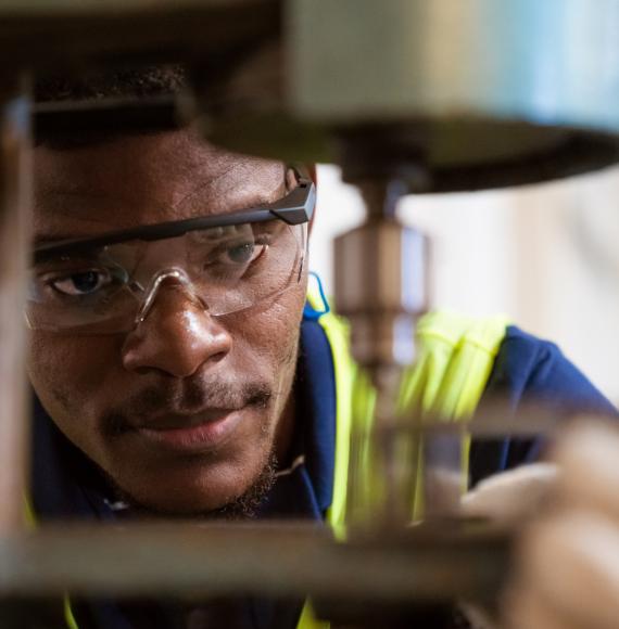 Engineer looking closely at a tool he is operating