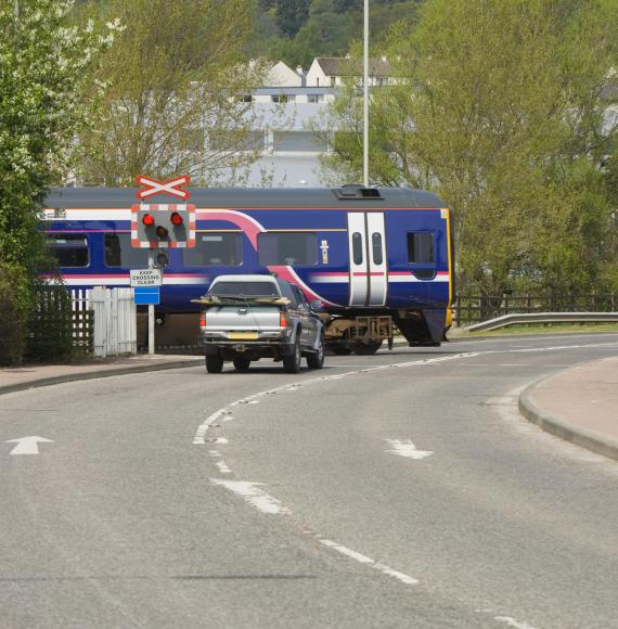 Train crossing a road at a level crossing