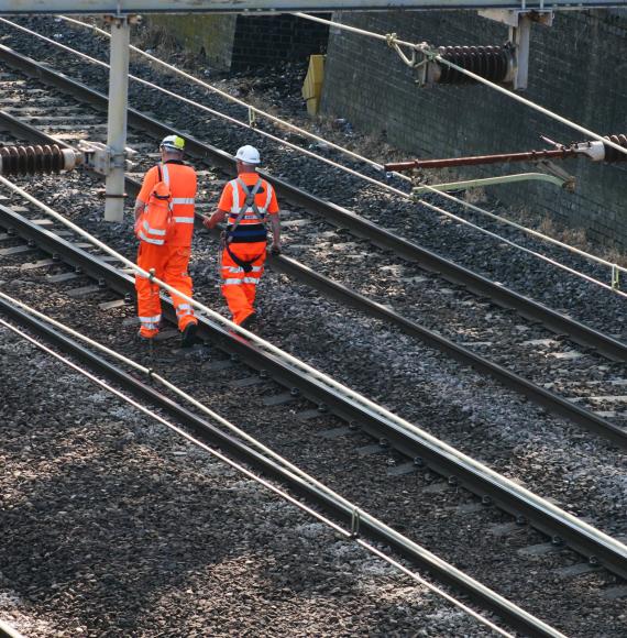 Two rail workers on the track
