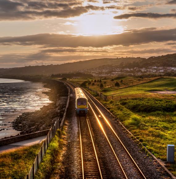 Train travelling through the countryside at sunset in Wales