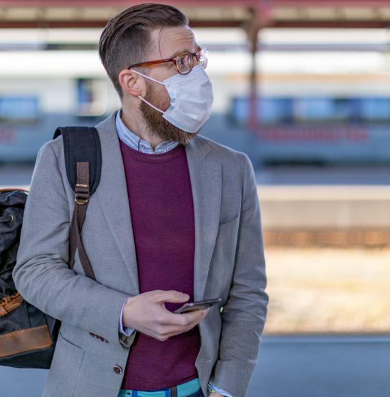 Passenger at a train station with phone