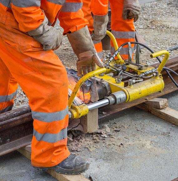 Weld trimmer being used by workers