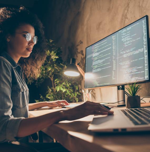 Young woman using a laptop to code