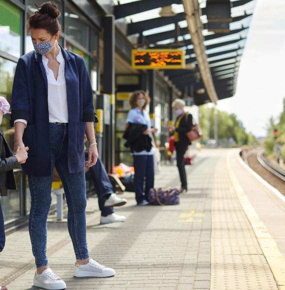 Mother and young daughter at a train platform