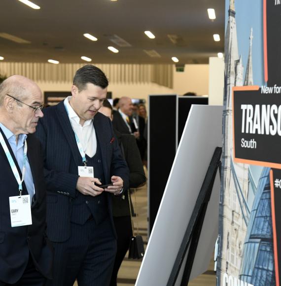 Attendees looking at exhibit at TCR Midlands 2022 event