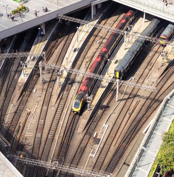 An aerial view of people walking on the pedestrianised paving above trains outside Birmingham's New Street station, in the city centre. Provided via Istock 