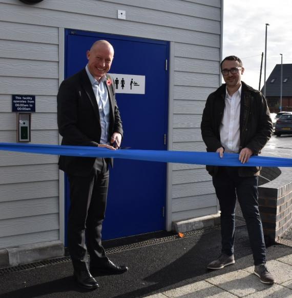 Chris Jackson and Simon Elliott open the new toilet pod by cutting a ribbon, via Northern