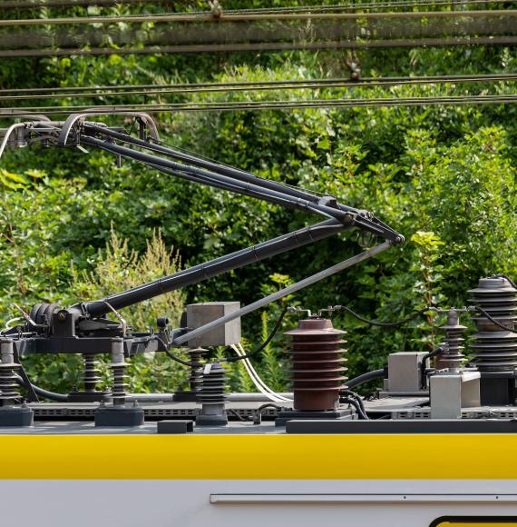 Electric train trolley pole, railway electrification system, overhead rig to supply energy for electric vehicle, via Istock 