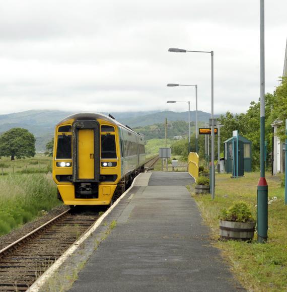 Railway diesel train locomotive at rural Talsarnau station, Gwynedd in North Wales UK, via Istock