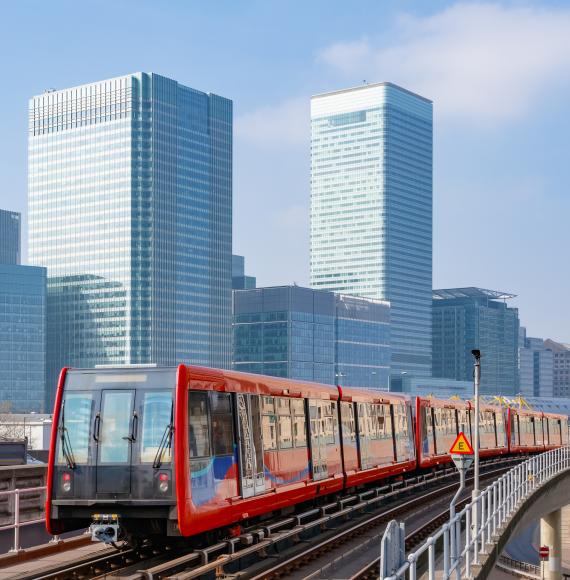 Docklands light railway in London with Canary Wharf in the background, via Istock 