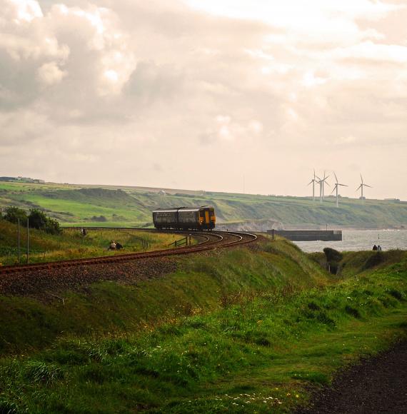 A railway carriage in front of a lake with a cloudy sky in the background, Whitehaven, Cumbria, England
