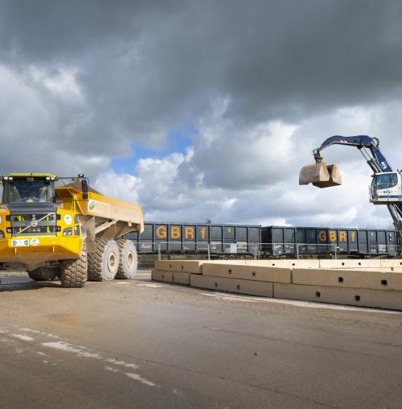 Material delivered by rail to Quainton railhead is taken away on an articulated dumper truck Feb 2024