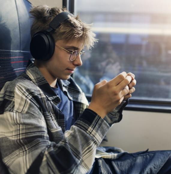 Teenage boy travelling by modern train