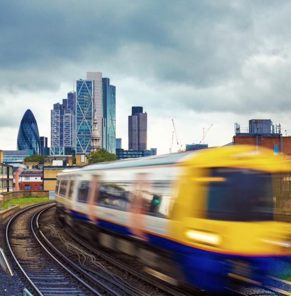 London Overground train in front of London skyline