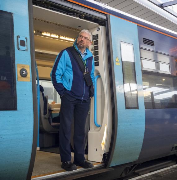Train guard standing in the train door