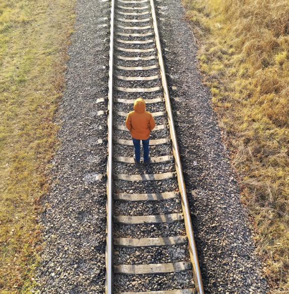 Man stood on train tracks