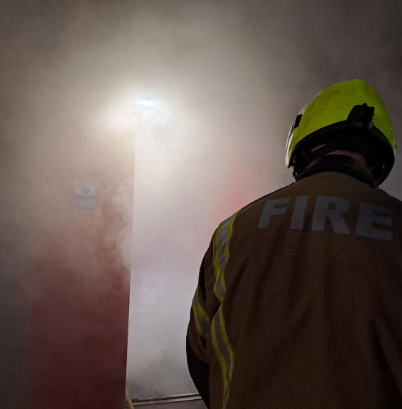 Fireman in smokey room