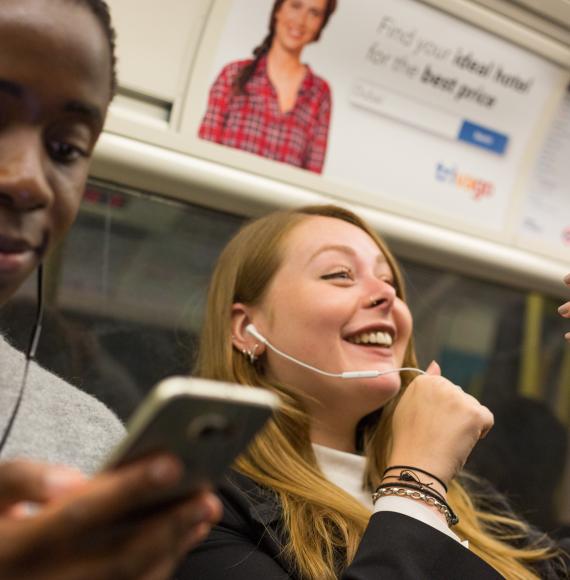 People using mobiles on the tube