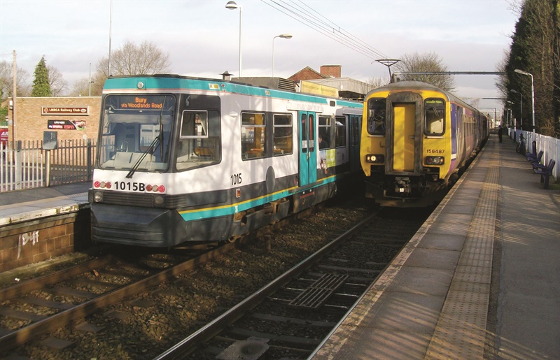 511 tram next to a train