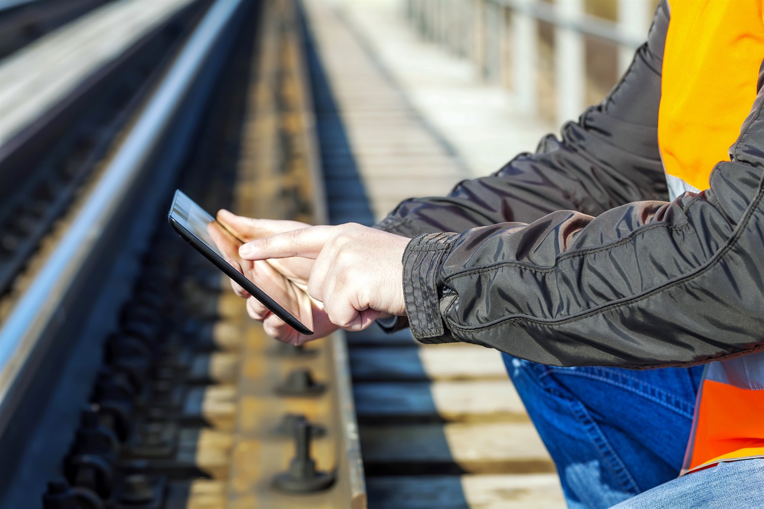 Worker using tablet trackside c. ilze79 edit